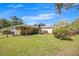Expansive backyard featuring mature trees, well-maintained lawn and deck at 4164 Weston Dr, Powder Springs, GA 30127