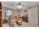 Neutral bedroom with a ceiling fan, a double window, and clutter throughout at 4164 Weston Dr, Powder Springs, GA 30127