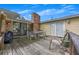 View of the deck with brick fireplace and dining table with chairs at 4164 Weston Dr, Powder Springs, GA 30127