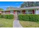 Close-up of a charming brick home with decorative window shutters and a paved walkway at 4164 Weston Dr, Powder Springs, GA 30127