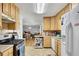 Open kitchen flows into the living area, featuring light wood cabinets, modern appliances, and ample counter space at 4164 Weston Dr, Powder Springs, GA 30127