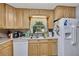 Well-lit kitchen with light wood cabinets, double sink, and ample counter space for meal preparation at 4164 Weston Dr, Powder Springs, GA 30127