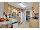 Functional kitchen featuring light wood cabinetry, a breakfast bar, and modern appliances at 4164 Weston Dr, Powder Springs, GA 30127