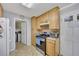 Efficient kitchen with stainless steel range, ample cabinet space, and an adjacent laundry area at 4164 Weston Dr, Powder Springs, GA 30127