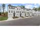 Neat row of townhomes with attached garages, clean landscaping, and similar architectural designs at 148 Werner Brook Sw Way, Atlanta, GA 30354