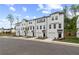 Community of townhomes, featuring coordinated white exteriors, garages, and landscaping, situated along a street at 148 Werner Brook Sw Way, Atlanta, GA 30354