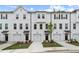 Stylish townhomes with white exteriors, private garages, neat landscaping, and a contemporary design at 148 Werner Brook Sw Way, Atlanta, GA 30354