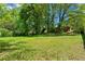 Spacious backyard with healthy green grass and mature trees offers plenty of room at 2307 Woodridge Dr, Marietta, GA 30066