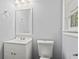 Clean bathroom features a white toilet, vanity and matching accessories providing a minimalist appeal at 2307 Woodridge Dr, Marietta, GA 30066