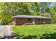Charming single-story brick home with mature trees and a well-maintained lawn at 2307 Woodridge Dr, Marietta, GA 30066