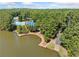 Aerial view of the community lake, pool, clubhouse, and dock areas at 374 Meadowmeade Cv, Lawrenceville, GA 30043