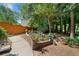 Beautifully landscaped backyard with a garden, pathway, and wooden fence, creating a private outdoor retreat at 374 Meadowmeade Cv, Lawrenceville, GA 30043
