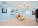 Finished basement with a recliner, table and chairs, white trim, light blue walls, and a ceiling fan at 374 Meadowmeade Cv, Lawrenceville, GA 30043