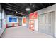 Unfinished basement with gray concrete floor, a red workbench, and a Honda racing flag on the wall at 374 Meadowmeade Cv, Lawrenceville, GA 30043