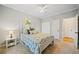 Cozy bedroom featuring a floral bedspread, ceiling fan, and natural light at 374 Meadowmeade Cv, Lawrenceville, GA 30043