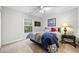 Cozy bedroom with a large window, TV, and a comfortable bed with decorative pillows at 374 Meadowmeade Cv, Lawrenceville, GA 30043