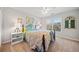 Cozy bedroom featuring a plush bed, neutral walls, and natural light from a window at 374 Meadowmeade Cv, Lawrenceville, GA 30043