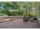 Spacious deck with outdoor seating, an orange umbrella, and a cozy fire pit, ideal for relaxing and entertaining at 374 Meadowmeade Cv, Lawrenceville, GA 30043