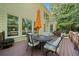 Inviting outdoor deck features seating, an orange umbrella, and a fire pit, perfect for entertaining guests at 374 Meadowmeade Cv, Lawrenceville, GA 30043