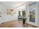 Bright dining area with hardwood floors, modern lighting, and a door to a deck or patio at 374 Meadowmeade Cv, Lawrenceville, GA 30043