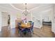 Dining room with a chandelier, hardwood floors, and elegant decor, ideal for Gathering gatherings and entertaining at 374 Meadowmeade Cv, Lawrenceville, GA 30043