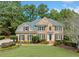 Charming brick two-story home with a well-maintained lawn and mature landscaping for great curb appeal at 374 Meadowmeade Cv, Lawrenceville, GA 30043