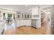 Open-concept kitchen featuring white cabinets, stainless steel appliances, and breakfast bar at 374 Meadowmeade Cv, Lawrenceville, GA 30043