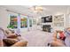 Living room featuring built-in shelving, a fireplace, and a view of the deck through a large window at 374 Meadowmeade Cv, Lawrenceville, GA 30043