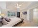 Main bedroom with tray ceiling, carpet flooring, a large window, and a walk-in closet at 374 Meadowmeade Cv, Lawrenceville, GA 30043