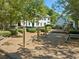 Community playground featuring swings and various activities, surrounded by trees and benches at 374 Meadowmeade Cv, Lawrenceville, GA 30043