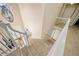 Open staircase with carpeted steps, white railings, and natural light from a nearby window at 374 Meadowmeade Cv, Lawrenceville, GA 30043