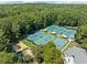Aerial view of community tennis courts with lush landscaping, located in a well-maintained neighborhood at 374 Meadowmeade Cv, Lawrenceville, GA 30043