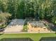 Aerial view of a sand volleyball court and outdoor recreation area with games at 374 Meadowmeade Cv, Lawrenceville, GA 30043