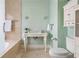 Clean bathroom with neutral colors, a large sink, toilet, and a bathtub at 479 Shannon Sw Dr, Atlanta, GA 30310