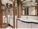 Stylish bathroom featuring a unique vanity, decorative mirror, and architectural elements at 479 Shannon Sw Dr, Atlanta, GA 30310