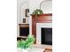 Close up of the fireplace with a stylish mirror and plant on the mantle at 479 Shannon Sw Dr, Atlanta, GA 30310