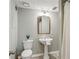 Half-bathroom featuring pedestal sink, modern fixtures, and tiled floors at 550 Ambergate Ct, Roswell, GA 30076