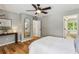 Cozy bedroom with hardwood flooring, neutral walls, and a ceiling fan at 550 Ambergate Ct, Roswell, GA 30076