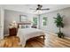 Bright bedroom with hardwood floors, neutral walls, and two windows at 550 Ambergate Ct, Roswell, GA 30076