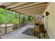 Second-story deck with stairs to the backyard, furniture, and wooded views at 550 Ambergate Ct, Roswell, GA 30076