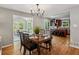 Elegant dining room with hardwood floors and connections to the kitchen and sunroom at 550 Ambergate Ct, Roswell, GA 30076