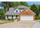 Charming two-story home with brick accents and a well-manicured front yard at 550 Ambergate Ct, Roswell, GA 30076