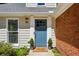 Close-up of the front door with blue paint and decorative plants at 550 Ambergate Ct, Roswell, GA 30076