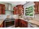 A well-equipped kitchen with stainless steel appliances and granite countertops at 550 Ambergate Ct, Roswell, GA 30076