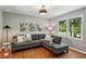Comfortable sitting area featuring a sectional sofa, large window, and hardwood floors at 550 Ambergate Ct, Roswell, GA 30076