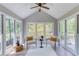 Bright and airy sunroom with tile floors, vaulted ceilings, and scenic views at 550 Ambergate Ct, Roswell, GA 30076