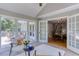 Serene sunroom with tile floors, offering views of the backyard and access to the deck at 550 Ambergate Ct, Roswell, GA 30076
