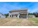 Spacious backyard featuring a covered patio with fan, perfect for outdoor entertaining at 119 Felicity Pike, Locust Grove, GA 30248
