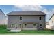 View of backyard featuring gray siding, windows, grass, and patio, showcasing the home's exterior and outdoor space at 119 Felicity Pike, Locust Grove, GA 30248