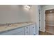 Bathroom featuring a double vanity with granite countertops and a walk-in closet at 119 Felicity Pike, Locust Grove, GA 30248